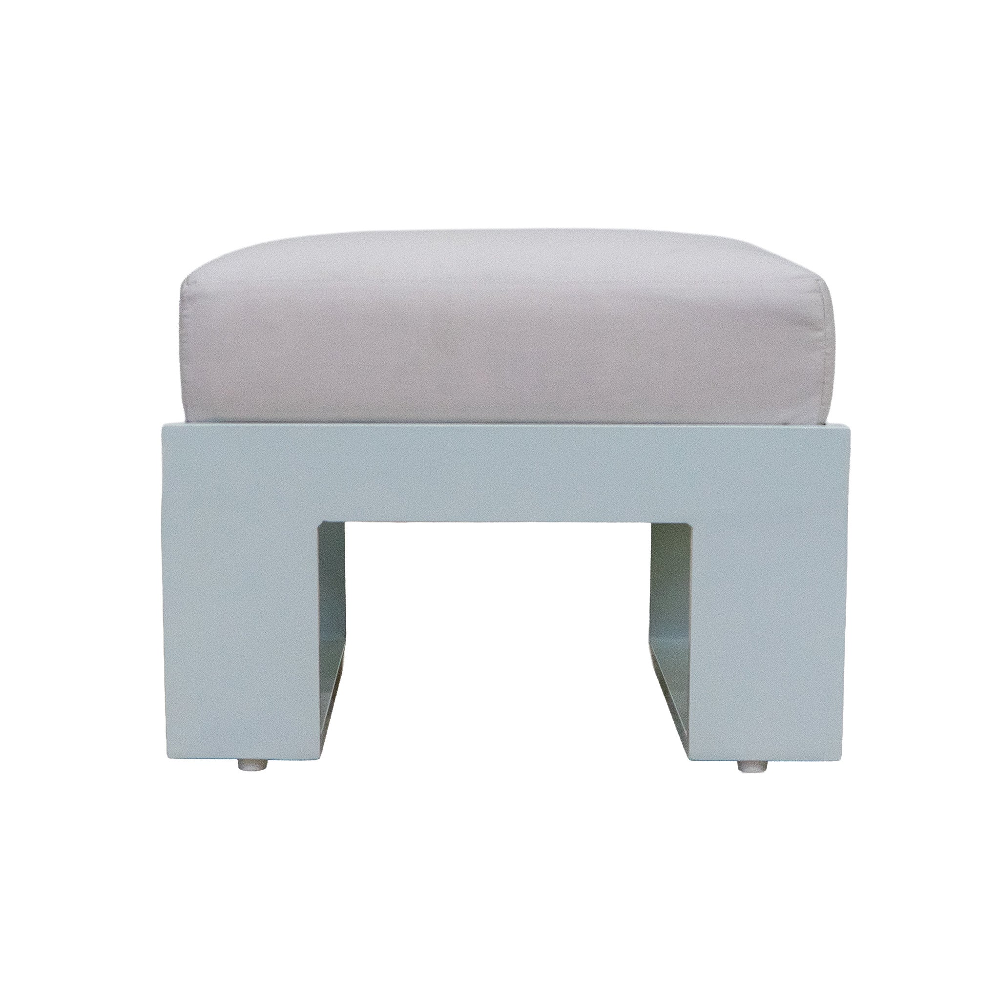 Side view of a white ottoman with an off white cushion. Studio image with a white background. 