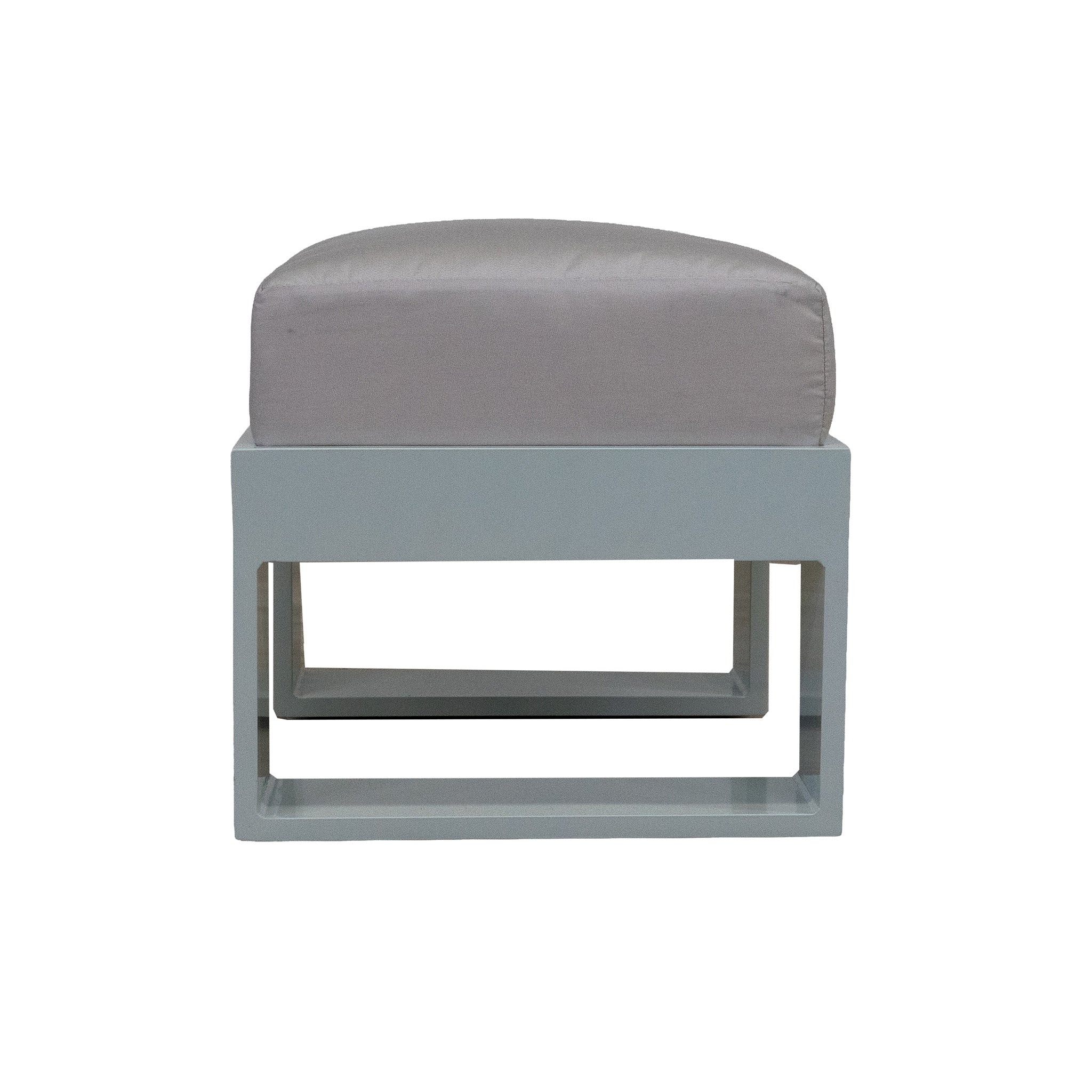 Side view of a white ottoman with an off white cushion. Studio image with a white background. 