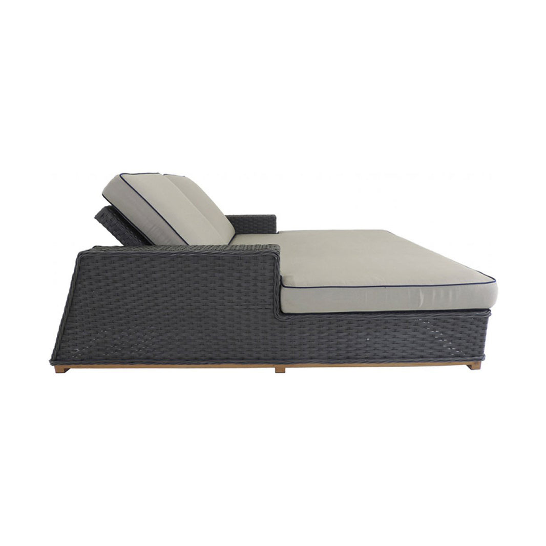 Side view of an outdoor daybed with beige cushions on a white background