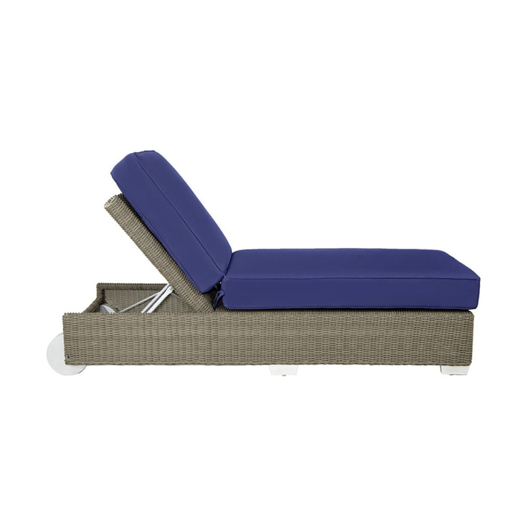Outdoor lounge chair with blue cushion on a white background
